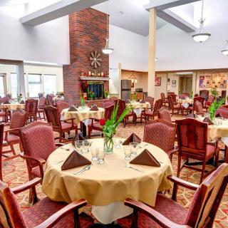 An elegantly decorated dining room with neatly arranged tables and chairs.