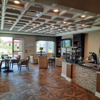 A modern cafe interior with a seating area and counter.