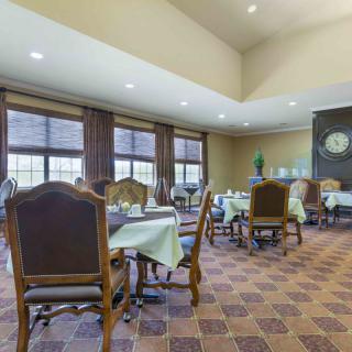 An elegant dining room with neatly arranged tables and chairs.