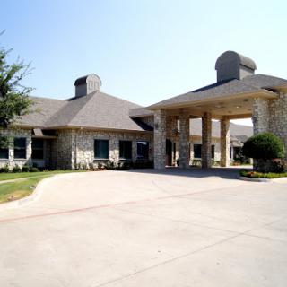 A charming residential building featuring stone architecture and a welcoming entrance.