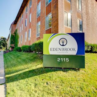 The entrance to Edenbrook, showcasing its welcoming sign and landscaped surroundings.