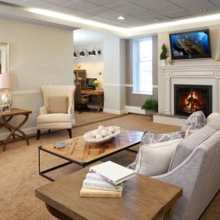 A cozy living room featuring a fireplace and modern decor.