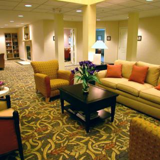 A cozy waiting room with comfortable seating and warm lighting.