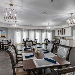 A modern and elegant dining room with neatly arranged tables and place settings.