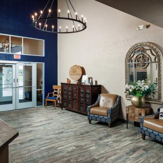 A cozy lobby with comfortable seating, decorative elements, and a large chandelier.