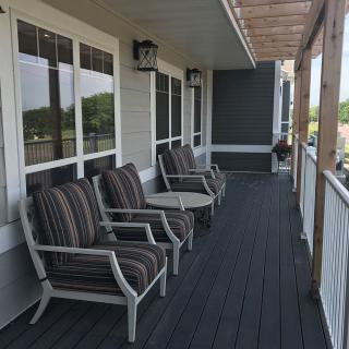 A cozy porch with comfortable seating and a small table.