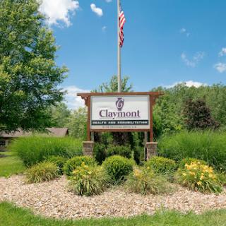 Entrance sign surrounded by lush landscaping and a clear blue sky.