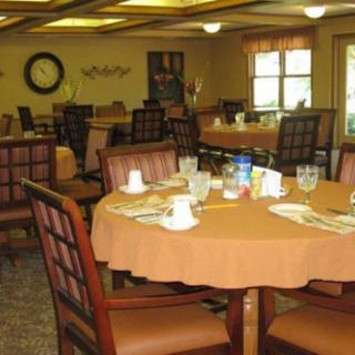 An empty dining room with neatly set tables, ready for guests.