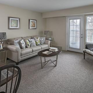 A cozy living room featuring a sofa, coffee table, and tasteful decor.