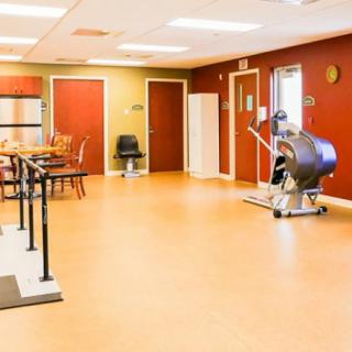 A rehabilitation center's therapy room equipped with exercise machines.