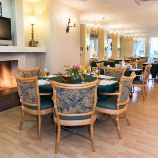 Elegant restaurant dining area with cozy fireplace and stylish furnishings.