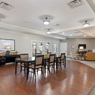 A spacious and modern dining area with hardwood floors and elegant lighting.
