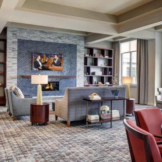 A modern living room with a fireplace and stylish furniture.