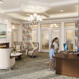 A hotel lobby with a reception desk, where a woman and child are checking in.