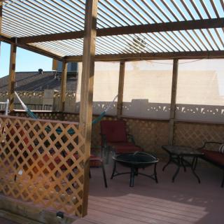 Outdoor patio with a pergola and seating area.