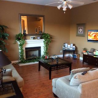 A cozy living room featuring a fireplace, comfortable seating, and warm decor.