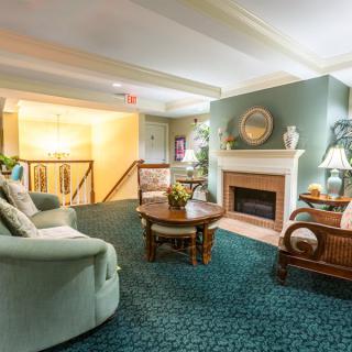 A cozy living room featuring a fireplace, comfortable seating, and tasteful decor.