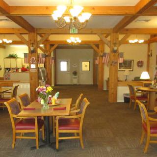 Cozy dining area with wooden beams and decorative lighting.