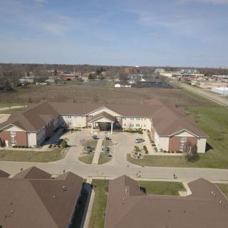Aerial view of a suburban building complex with landscaped grounds.