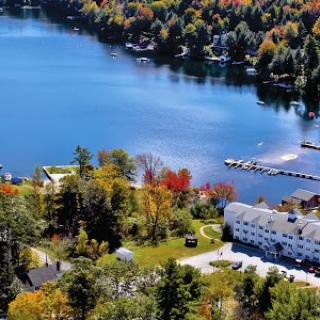 A picturesque view of a peaceful lake surrounded by vibrant autumn foliage.