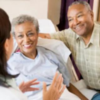 A patient receives support and care from a doctor and family member in a hospital setting.