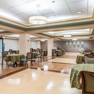 A spacious and elegantly decorated dining area with tables set for service.