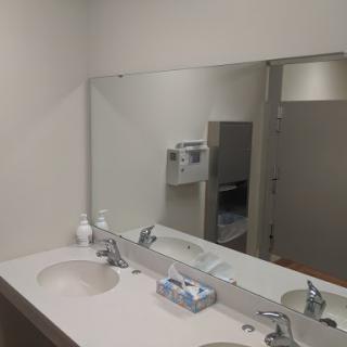 A modern bathroom featuring a sink and mirror.