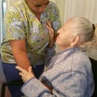A caregiver assists an elderly person with care and support.
