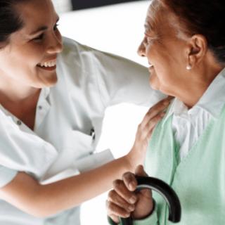 A nurse providing support to an elderly person.