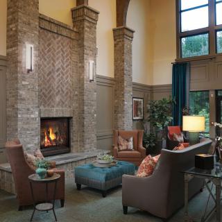 A cozy living room with a warm fireplace and modern decor.
