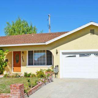 A suburban residential house with a garage and front yard.