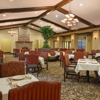 An elegant restaurant dining area with neatly set tables and comfortable seating.