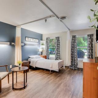 A well-lit and comfortable hospital room featuring modern furnishings and a cozy atmosphere.