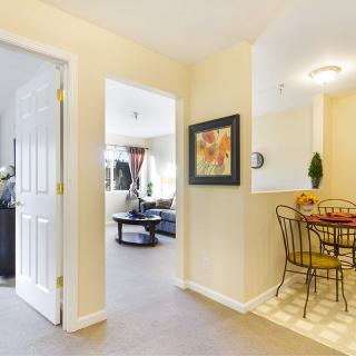 A cozy interior featuring a living room and dining area with modern furniture and artwork on the wall.