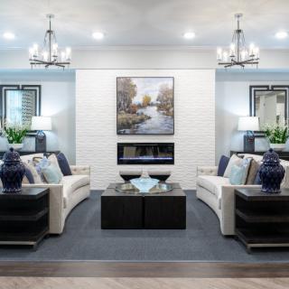 A modern living room with symmetrical furniture arrangement and elegant decor.