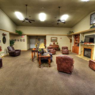 A spacious living room with comfortable seating and warm lighting.
