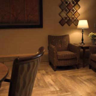 Cozy living room with comfortable armchairs and a warm lamp.