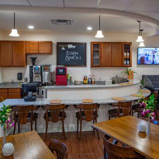 A cozy cafe interior with a bar counter and wooden furniture, creating a warm and inviting atmosphere.