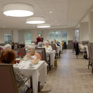 A cozy dining area filled with elderly patrons enjoying their meal and conversations.