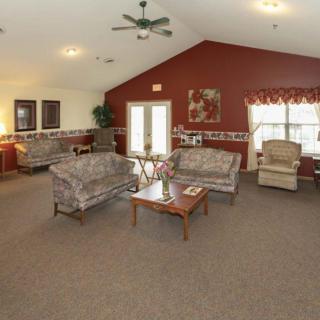 A cozy living room with sofas and a coffee table in a spacious interior.