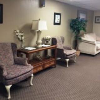 A cozy waiting room with plush chairs and decorative elements.