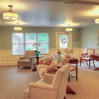 A cozy and well-lit living room with traditional decor featuring comfortable seating and elegant furniture.