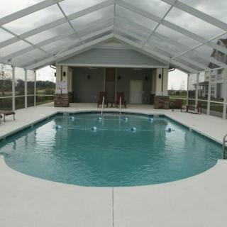 An enclosed indoor pool area with a transparent roof, providing a serene space for relaxation.