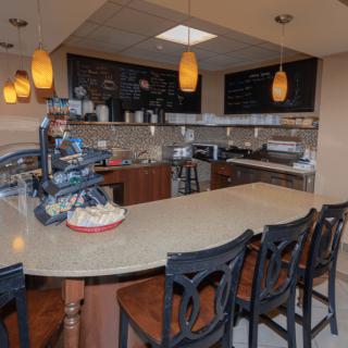 A cozy cafe interior with a bar counter and menu board.