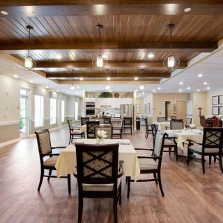 A spacious dining area with elegantly set tables and a warm, inviting atmosphere.