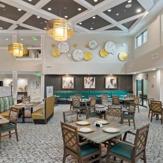 A modern dining area with stylish furniture, decorative wall art, and ambient lighting.