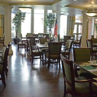 An empty dining room with tables and chairs neatly arranged.