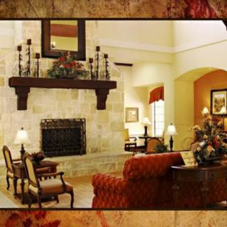 A cozy living room with a stone fireplace and stylish furnishings.
