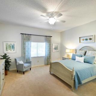 A well-decorated bedroom with a cozy bed and modern furnishings.