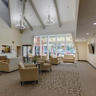 A spacious lobby with comfortable seating and large windows allowing natural light to fill the room.